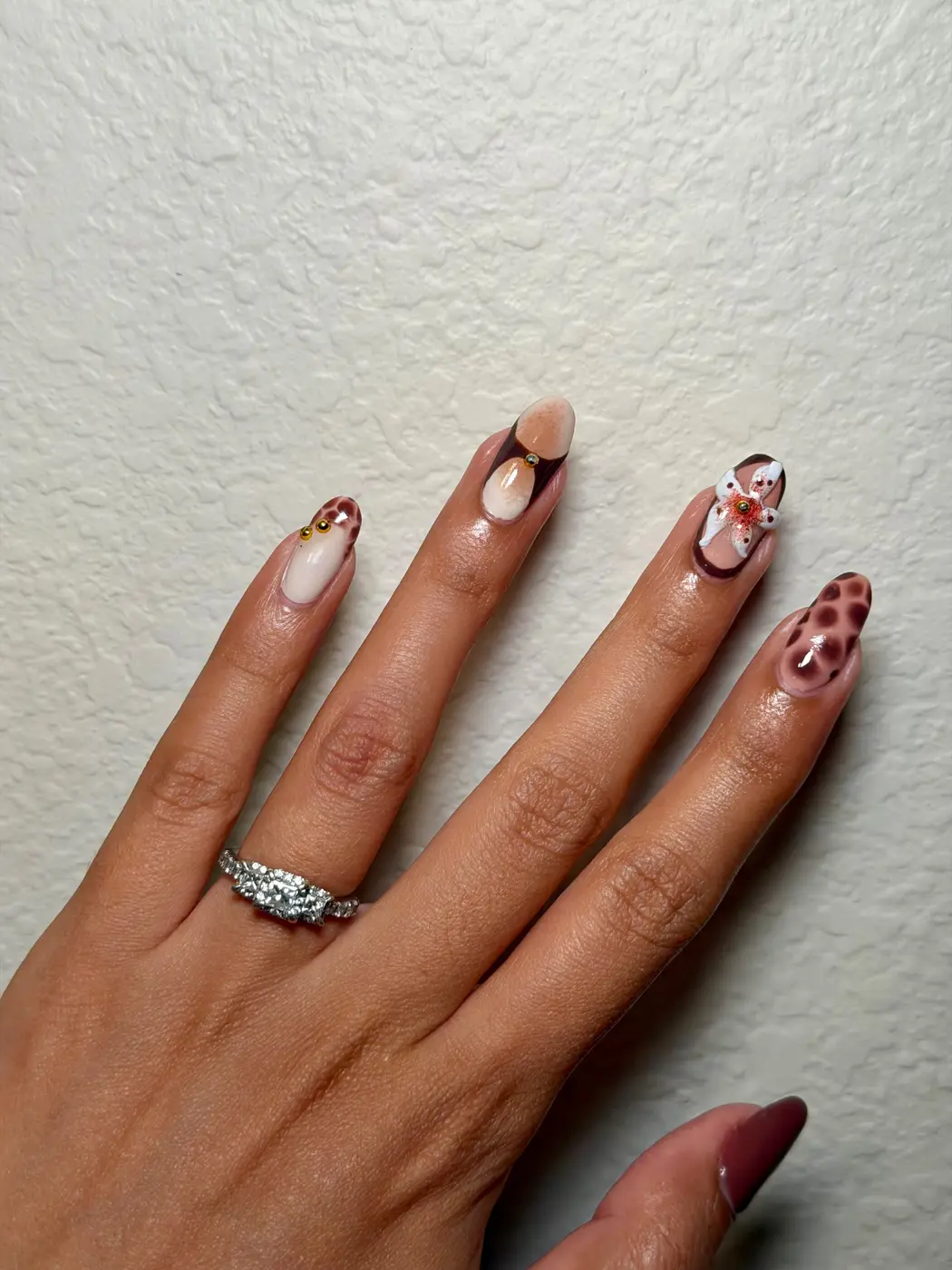 Nude and chocolate almond set with 3D florals and a leopard-print accent nail